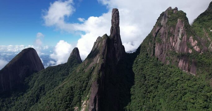 Sideways aerial movement with Finger of God peak showing panorama landscape of mountain range Serra dos Orgaos in Teresopolis part of Rio de Janeiro Atlantic rain forest on coastal Brazil