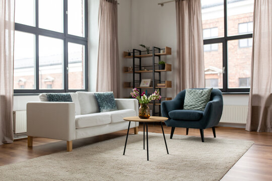 comfort, furniture and interior concept - sofa with cushions at cozy home living room