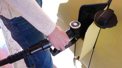 Ladi girl make a fuel gasoline diesel to her yellow car camper - increase of the cost of the fuel...