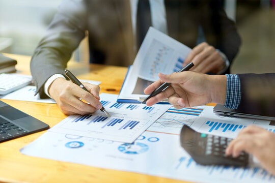 Financial management team discuss and analyse a financial strategy plans.