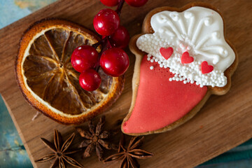 Festive gingerbread and candied fruits on a wooden board. Sweet food and holiday concept
