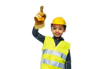building, construction and profession concept - smiling little boy in protective glove, yellow safety vest and helmet pointing finger up over white background