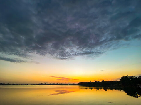 Sunrise reflection, huge cloud over lake © Christopherab