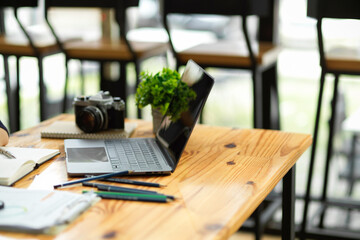 Modern portable laptop computer on wooden table. Workspace
