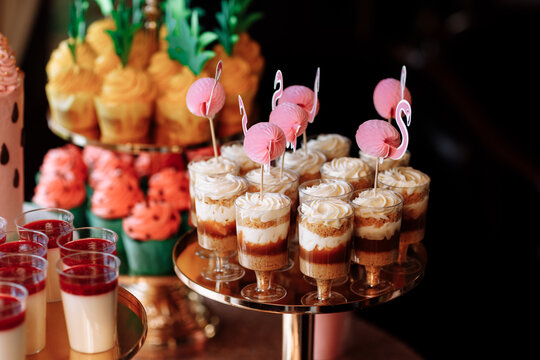 birthday exitic catering, table with modern desserts, cupcakes, sweets with fruits. delicious candy bar at expensive birthday party. space for text. baby shower. holiday celebration