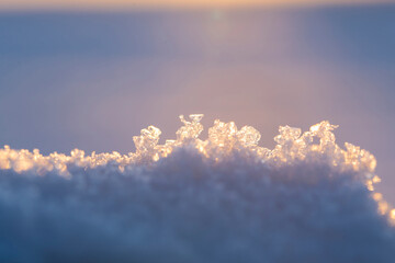 Abstract winter background. Snowflakes close-up at sunset. Selective focus. - 479732805