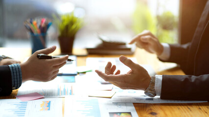 a businessmen discussing and analysing financial data works.