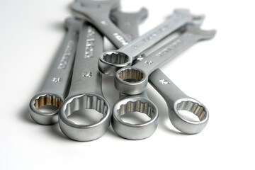 several open metal keys are in a pile. Close-up on white background