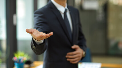 Businessman stretch hand for handshake greeting his partners