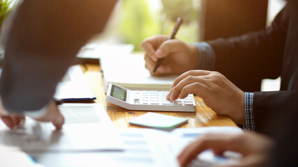 A team of male accountants calculating their company profit