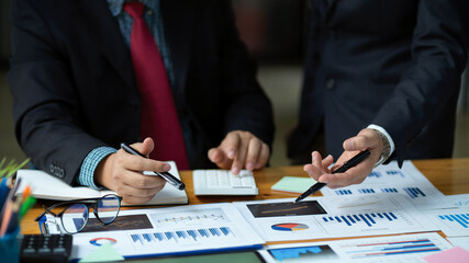 a male boss explains a financial strategy process to his worker