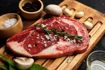 Tasty raw beef steak on a wooden board.