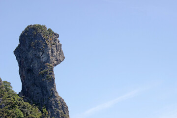 Strange shaped rock formation known as Chicken Island, Ao Phra Nang bay, Krabi, Thailand. Blue sky copy space to the right of frame.
