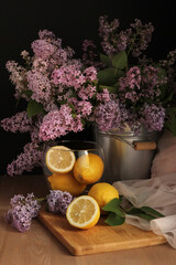 Lilac. Lemons. Still life with lilac and lemons. Low key.