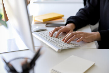 A female assistant or secretary working on desktop computer