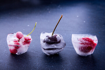 Frozen fruit and berries in ice cube 