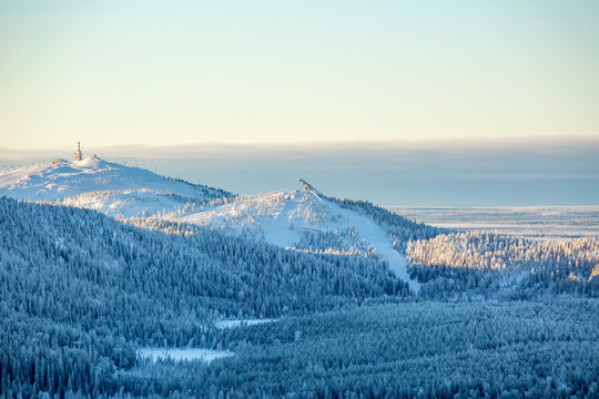 View of Ruka ski resort and the ski jumping hill during winter seen from Valtavaara hill, Finland, Europe