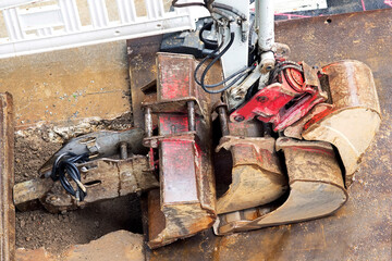different excavator shovels stacked on construction site for road maintenance