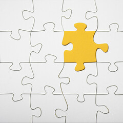Empty white details of puzzle on yellow background square, with space for text