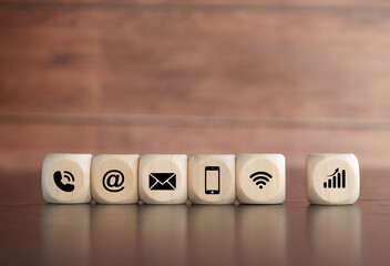 Wooden cube with icons of business communication, business process concept