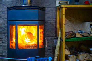 view of a metal furnace with tempered refractory glass, in which a bright flame of fire burns