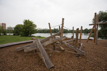 children's playground made of environment, eco-friendly materials. Wooden tree trunk sides, swings, net bridges, climbers. Beach number 2, Serebryany Bor (Silver Pinewood) forest park. Moscow, Russia