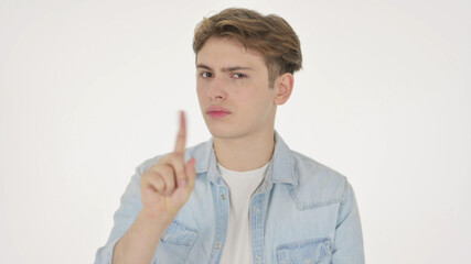 Young Man showing No Sign by Finger on White Background