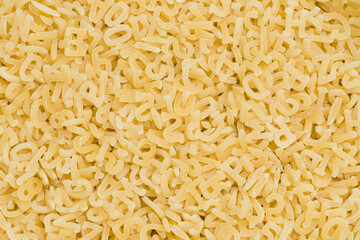 Alphabet pasta background or texture. Close up, top view   