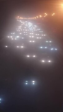 car headlights through cloudy glass, vertical video