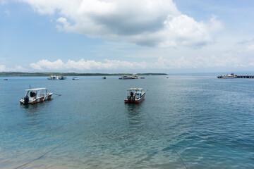 View of the sea and fishing boats anchored. Harbor in Nusa Penida, Bali.