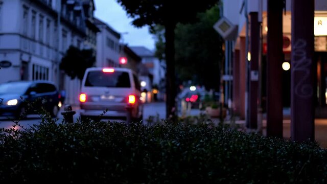 European evening city bad soden in defocus, vehicle is passing along the road, pedestrians are walking, a busy urban environment, lights are shining, concept business, travel, sights of Europe