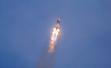 Take-off of a real launch vehicle from a spaceport. A rocket takes off into the sky against a background of clouds. Startup concept, power of science and technology.