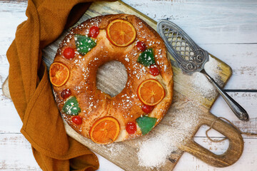 Roscón de reyes. Christmas typical spanish dessert on wooden background. Top view image