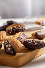 Vanilla madeleine cookies with chocolate and nuts