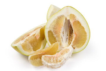 Half and slices of ripe pomelo on a white background
