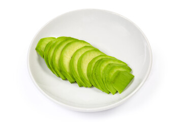 Sliced green avocado fruit on saucer on a white background