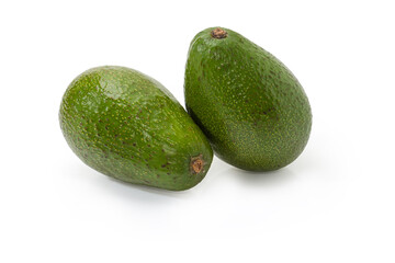 Two whole green avocado fruits on a white background