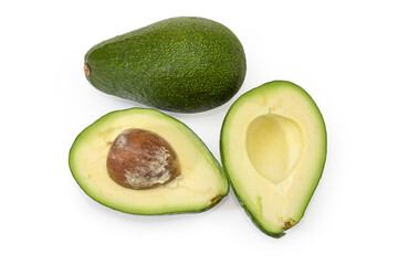 Whole and halved green avocado fruits on a white background