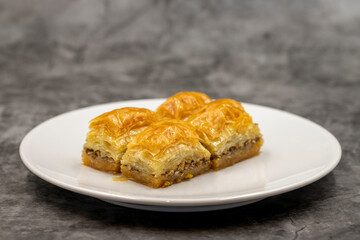 Walnut baklava on a dark background. Traditional Turkish cuisine delicacies. Close-up.