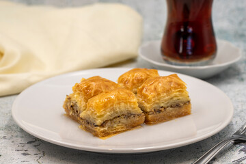 Walnut baklava on a stone background. Traditional Turkish cuisine delicacies. Close-up.