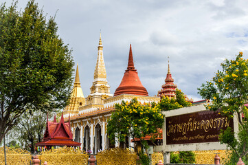 The unique design 3 pagoda roof with a signboard in thai name with the location at Wat Ratprakhongtham temple, Nonthaburi province, Thailand 