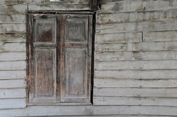 Wooden window closed lock on a wooden house texture pattern background.