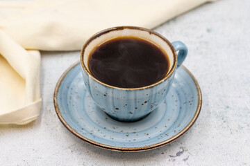 A cup of coffee on stone background. Close-up.
