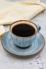 A cup of coffee on stone background. Close-up.