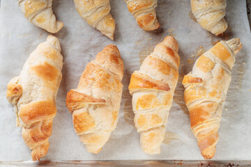 Top view of Homemade croissants on a baking paper.