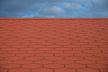 Roof with new red bitumen shingles close
