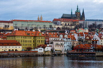 Fototapeta na wymiar Scenic view of the architecture of the Old Town from Charles Bridge over the Vltava River in Prague, Czech Republic. Historic buildings on the banks of the Vltava River.