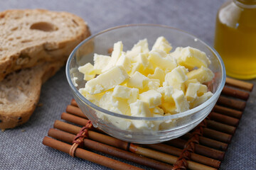 fresh butter in a container with bread on white background 