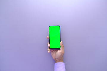  top view of young man hand using smart phone with green screen 