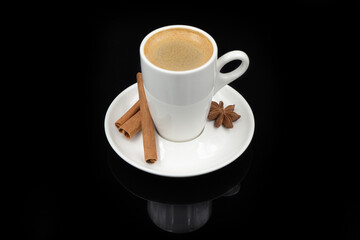 Black coffee in a cup on a black glass background.